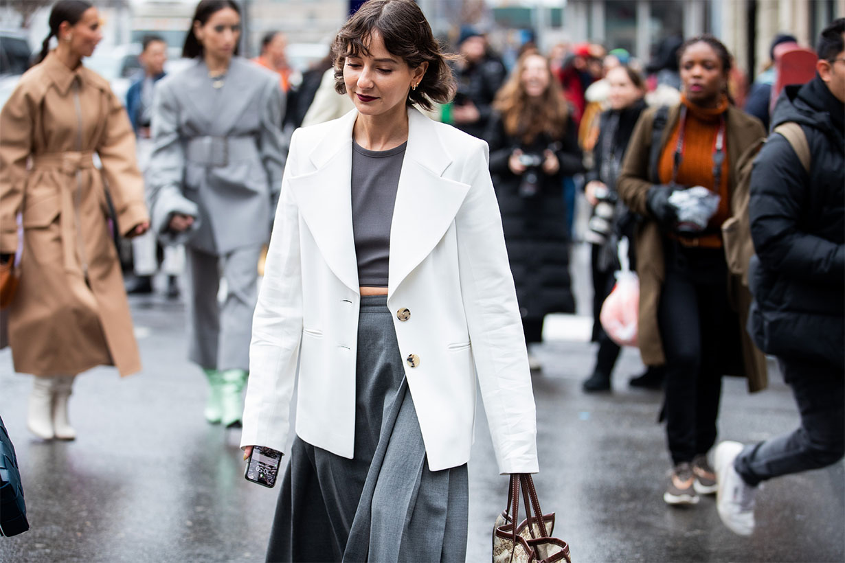 Alyssa Coscarelli is seen wearing cropped grey top, high waist skirt, white blazer outside Sally LaPointe during New York Fashion Week Fall / Winter on February 11, 2020 in New York City. 