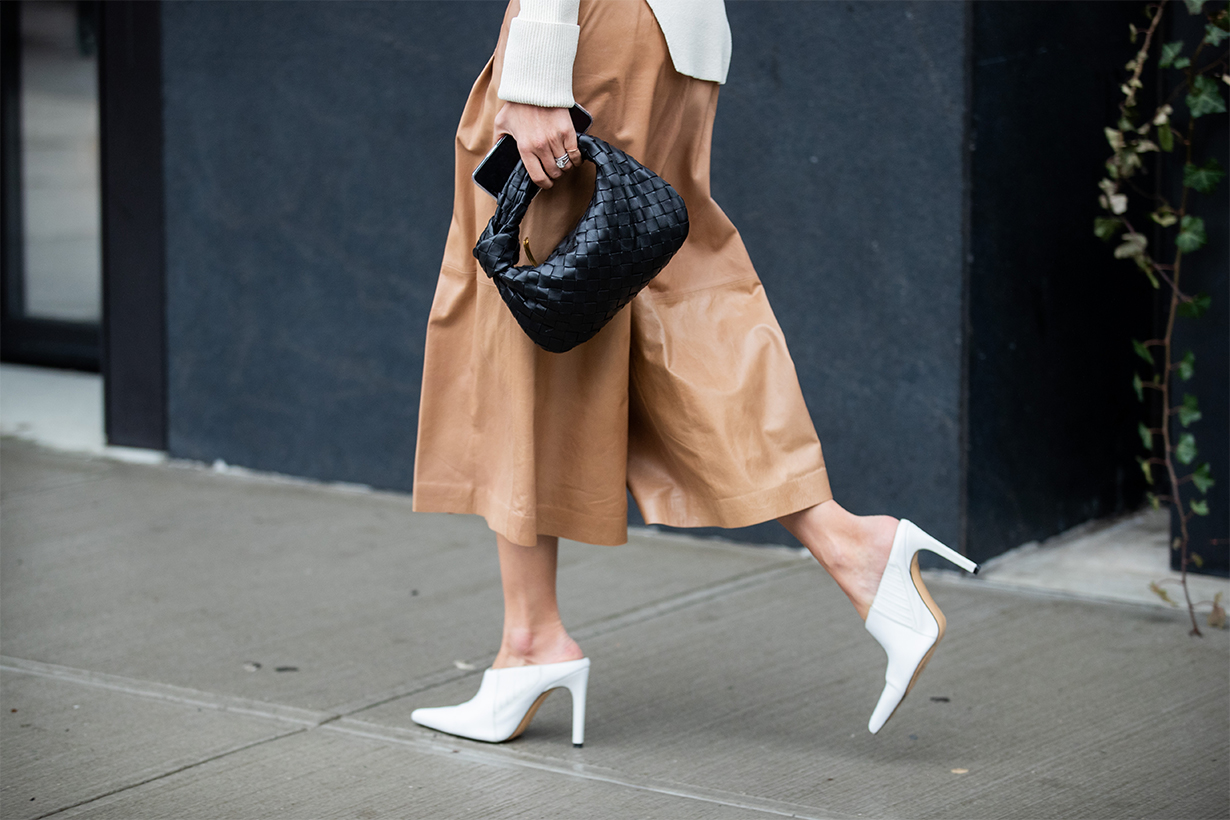 A guest is seen wearing black Bottega Veneta bag, beige cropped pants outside Tadashi Shoji during New York Fashion Week February 2020 on February 06, 2020 in New York City. 