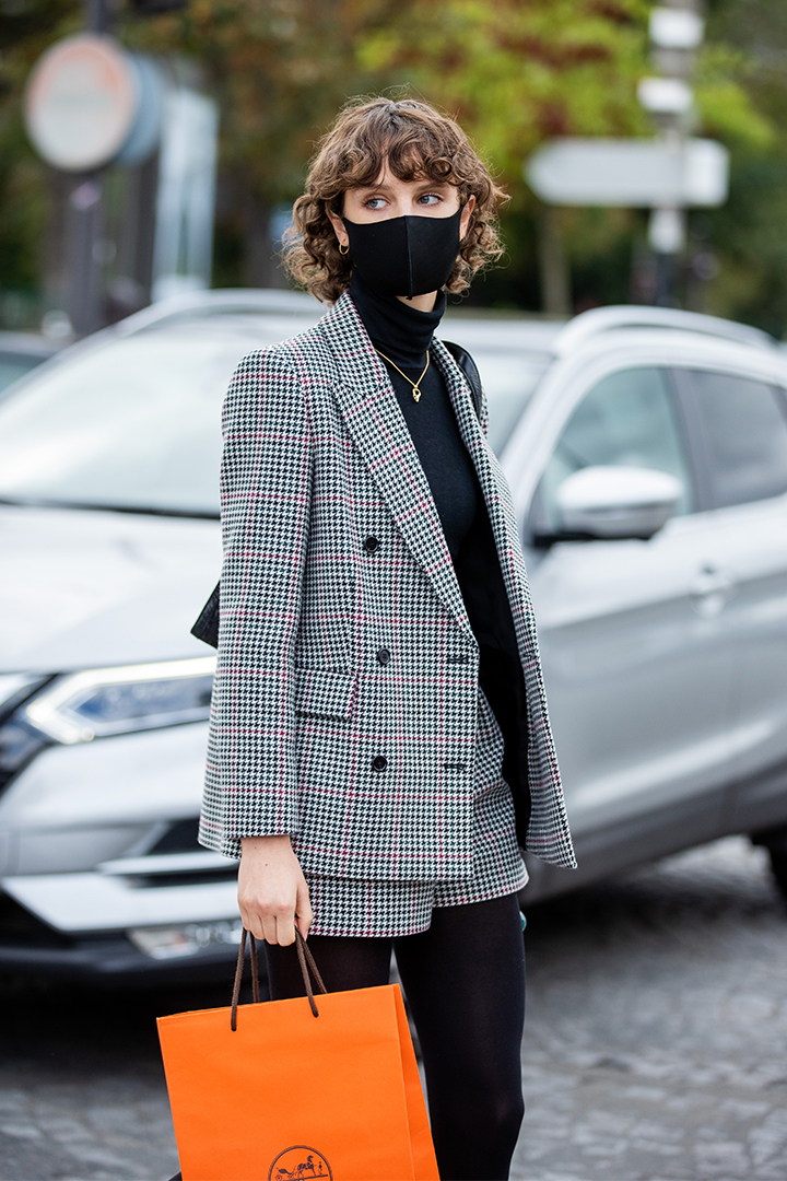 A model is seen wearing grey checked blazer and shorts, black turtleneck outside Hermes during Paris Fashion Week - Womenswear Spring Summer 2021 : Day Six on October 03, 2020 in Paris, France.